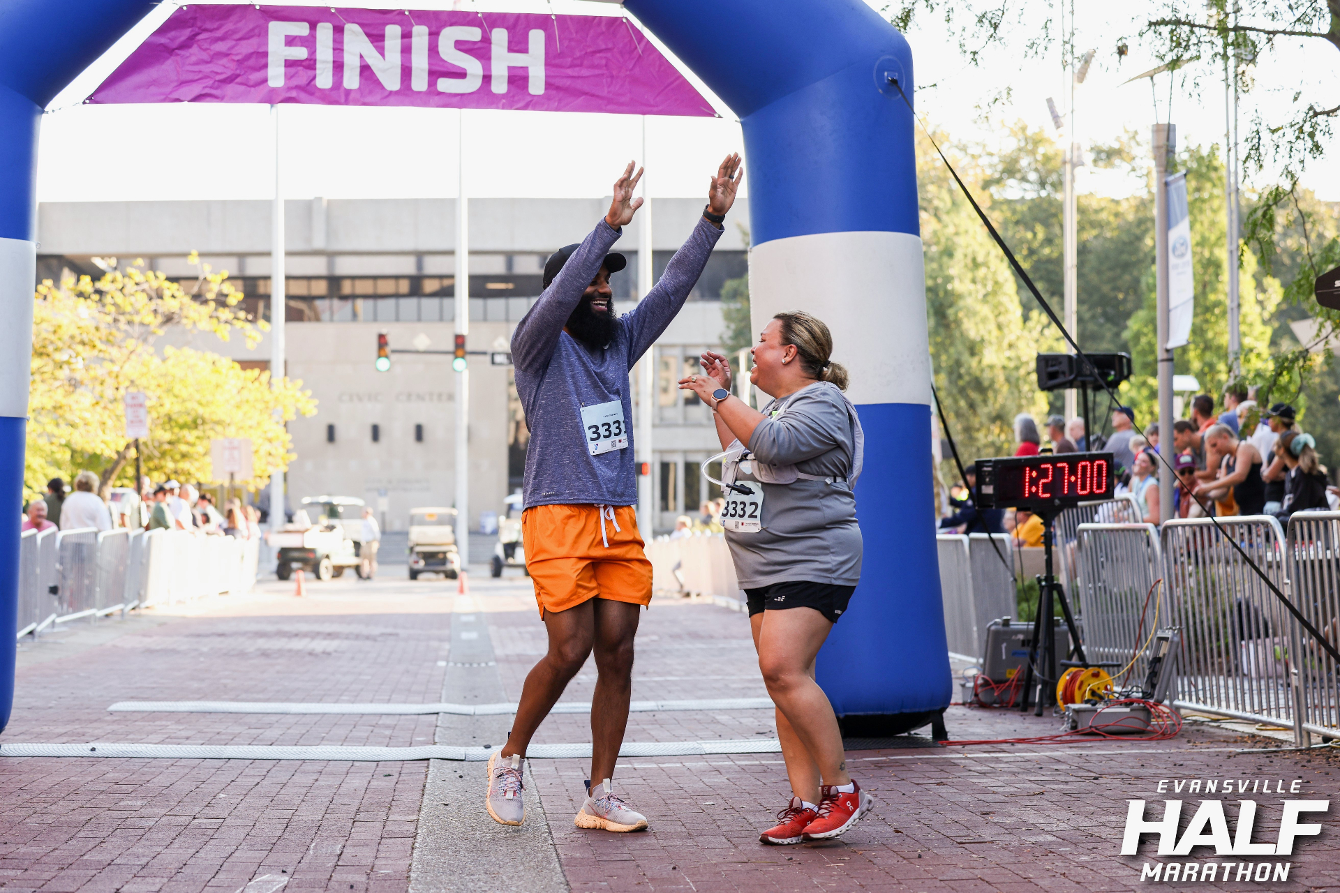 Coach T running with a client at the finish line